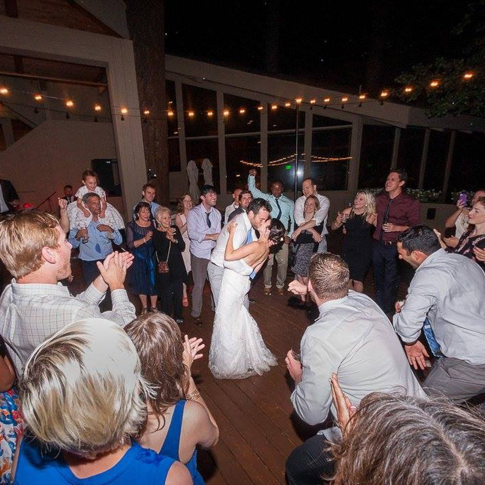 String lights at wedding with couple dancing